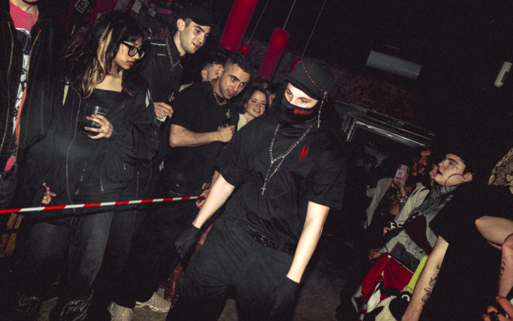Grupo de personas en una fiesta nocturna, con estética oscura y vestimenta alterna.